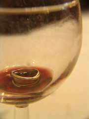 red wine with hand ring inside
